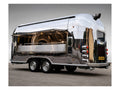 Polished stainless Airstream style food trailer with serving hatch and catering kitchen