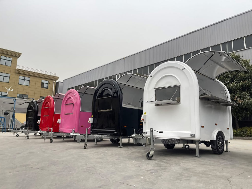 Compact colour coffee trailers lined up at supplier yard